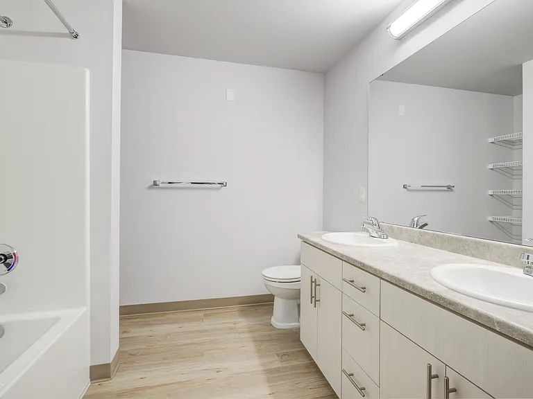 Bathroom, 2 sinks, toilet, tub and shelves