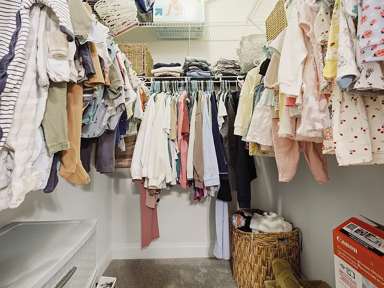 Walk-in closet inside of primary bathroom