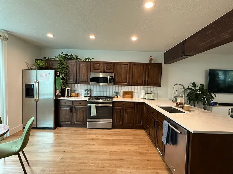 Kitchen, new gas range, fridge, microwave, dishwasher, and quartz countertops.