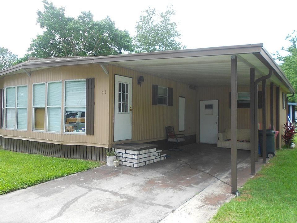 EXTERIOR SHOWING CARPORT & LAUNDRY/STORAGE ROOM