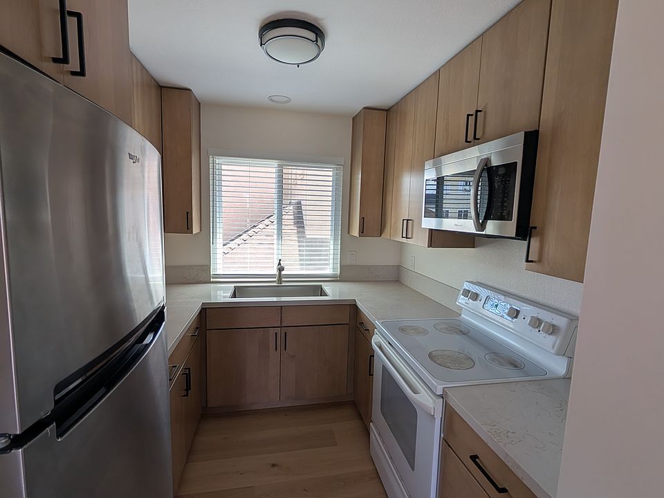 Newly remodeled kitchen - new fridge, granite countertops, sink, and shelves.