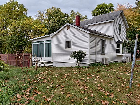 Side toward Stone Creek. Mini splits, large sunporch on the left. Privacy fence goes to the end of property.