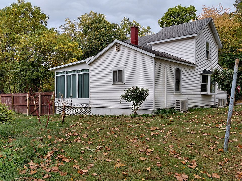 Side toward Stone Creek. Mini splits, large sunporch on the left. Privacy fence goes to the end of property.