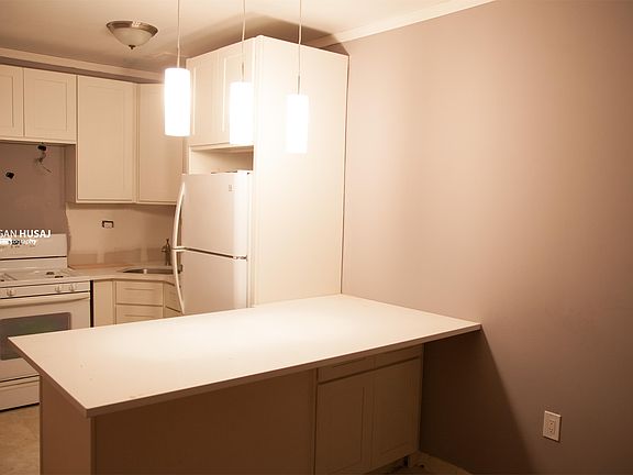 Brand new kitchen with stone countertop.