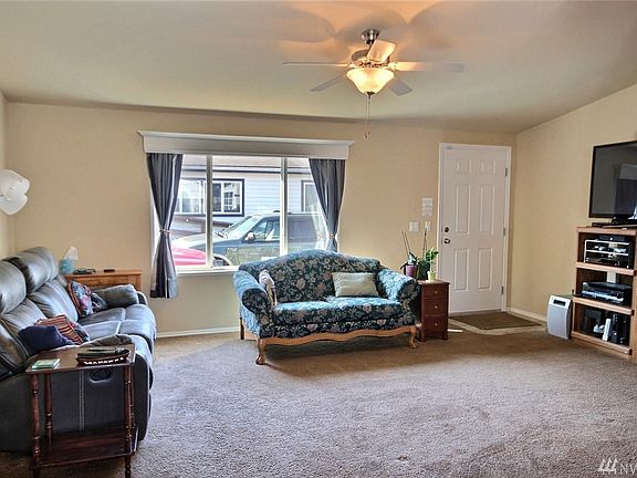 The living room looking towards the front door.  Note the large picture window adding lots of light!