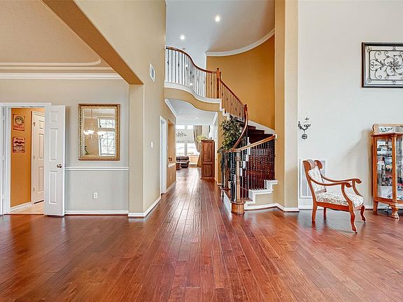 Stunning wood floors greet you upon entry along with a spiral staircase that adds elegance to the foyer.