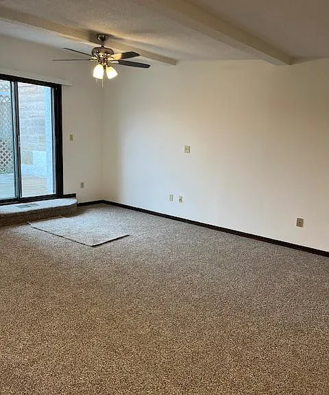 Large living room, with sliding glass door to patio.
