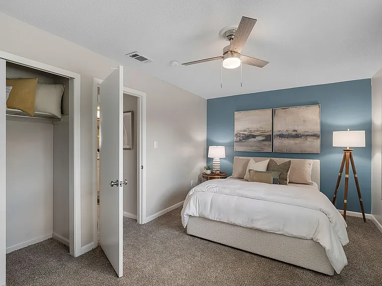 Bedroom with carpet, generous closet space, & ceiling fan