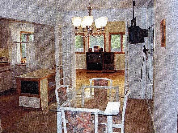 bright and open formal dining room that opens up to a sun/family room addition