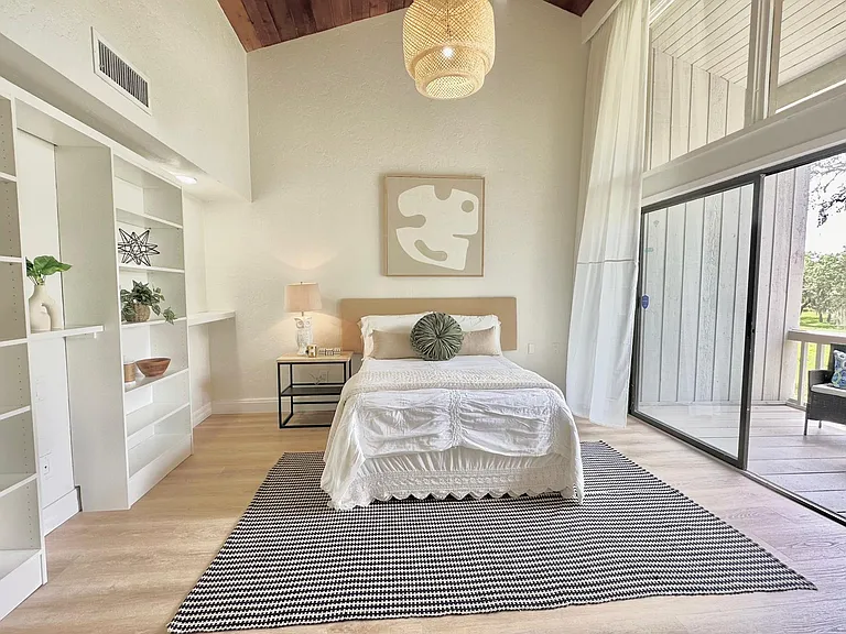 Large window wall where plenty of natural light comes in with a large curtain system.