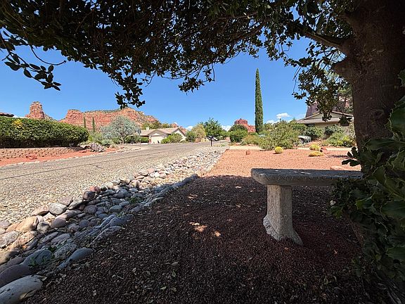 View or castle rock and bell rock from meditation bench in front yard under shaded tree