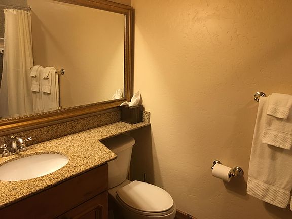 Bathroom with tub and shower, granite countertops tops.