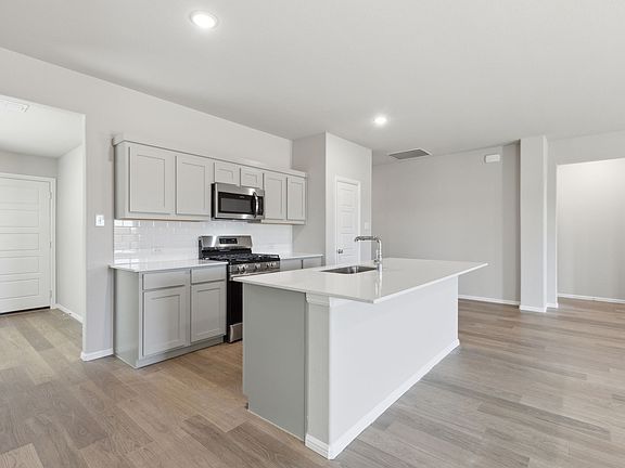 Kitchen in the Harrison home plan by Trophy Signature Homes - REPRESENTATIVE PHOTO