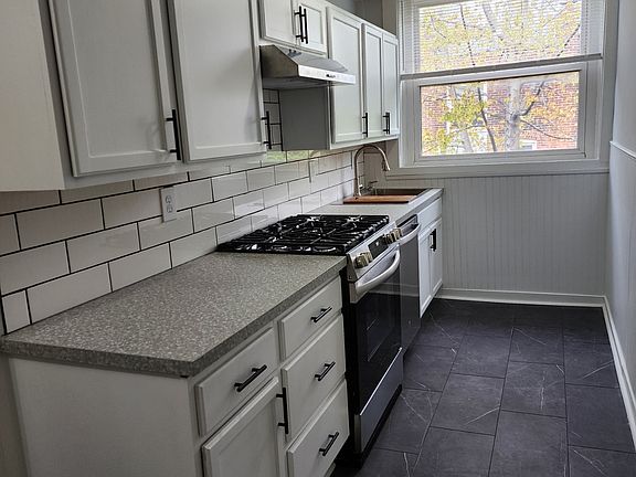 One side of the kitchen with new appliances including dishwasher