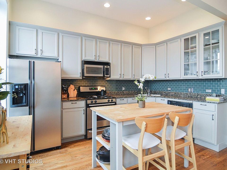 Open kitchen with a central island and bar cart.