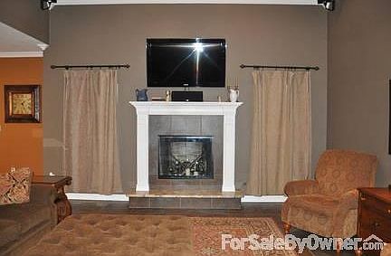 Open Gathering/Living Room
						:
						Custom hearth and surround, theater surround sound for gathering/entertaining.