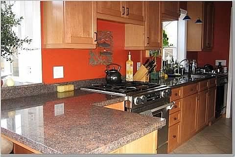 Updated kitchen with granite slab counter tops, stainless st