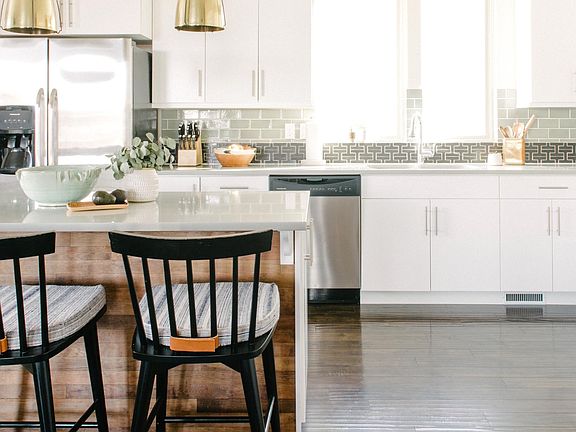Open floor plan kitchen with stainless steel appliances.