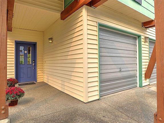 Spacious end unit with luscious landscaping, private decking, and secluded backyard.