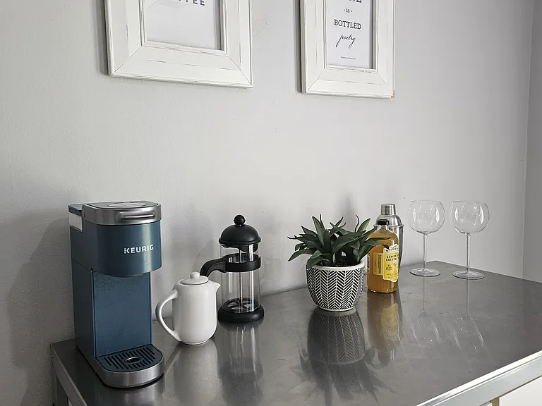 Stainless steel topped coffee and wine bar with tons of storage outfitted for your use.