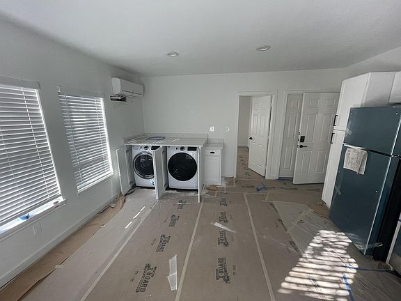 Hidden in-unit washer/dryer with quartz countertops.