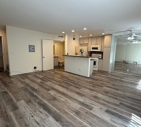 Living room view of open floor plan facing kitchen.