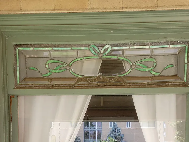 Stained glass is featured in front window of living room