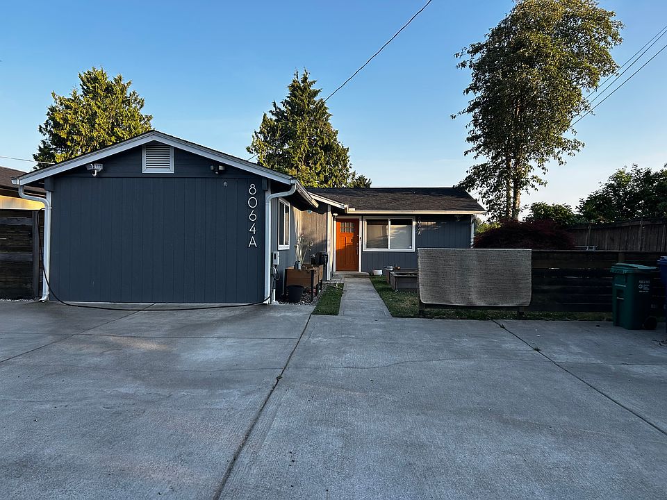 Front of house with parking for 3 cars plus EV chargers. Six garden beds ready to be. used!