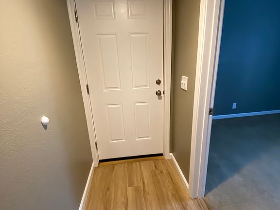 Back of front door. 
First bedroom or home office on right.