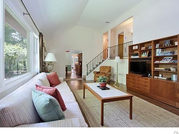 Living room leads to formal dining room. Few stairs to upper level for bedroomsand 2 full baths