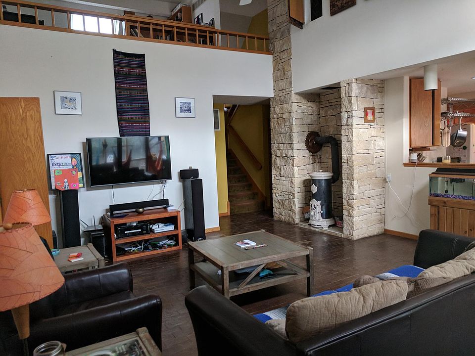 Living room, shows upstairs loft and opening to kitchen
