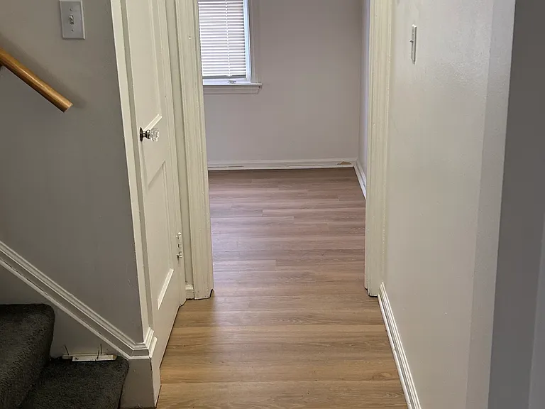 Seamless flow from upper level to kitchen with updated flooring throughout.