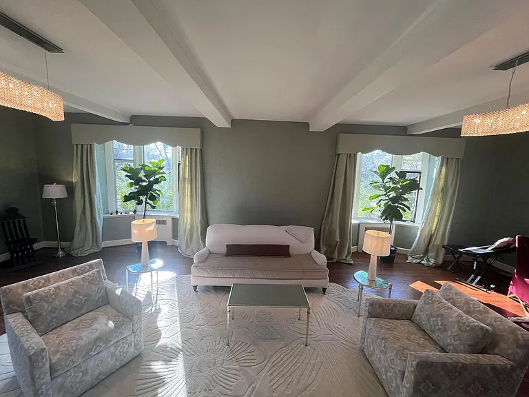 Hand-applied custom wall work. Beams. Swathed in light from windows on three sides. Very large formal living room