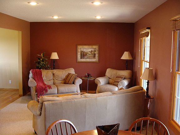 Living Room w/ Large Front Windows with Wood Venetian Blinds