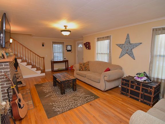 Large living room with oak floors and fireplace