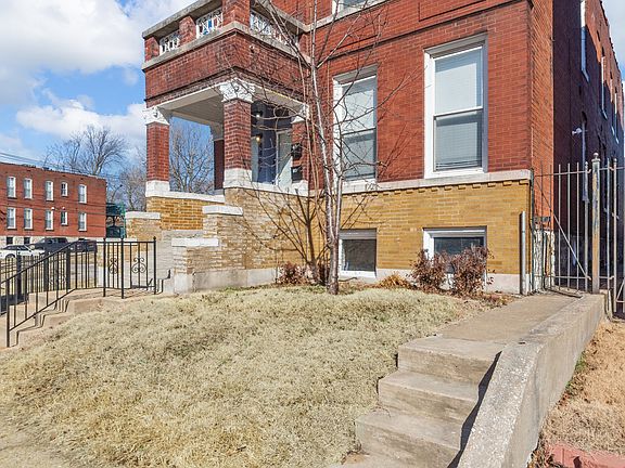 Access through gate to rear of building with fenced yard and parking pad