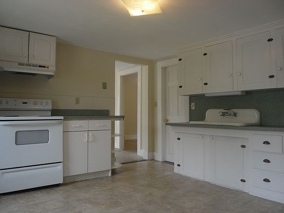 Farm sink is the anchor of kitchen with lots of counter space and cabinet storage.