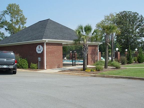 View of cabana and pool from parking lot