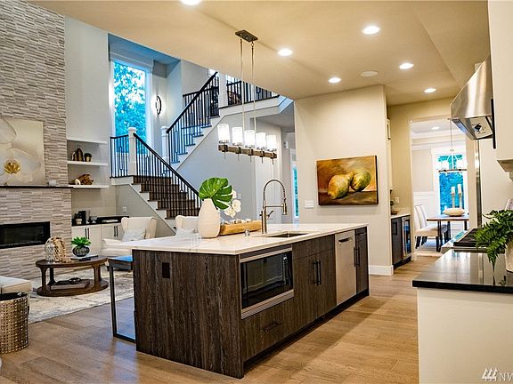 The professional kitchen is fit for a chef! Featuring Subzero refrigerator freezer, 6 burner Wolf Range Double Oven and Wolf Microwave plus beverage/wine cooler and expansive quartz surfaces.  