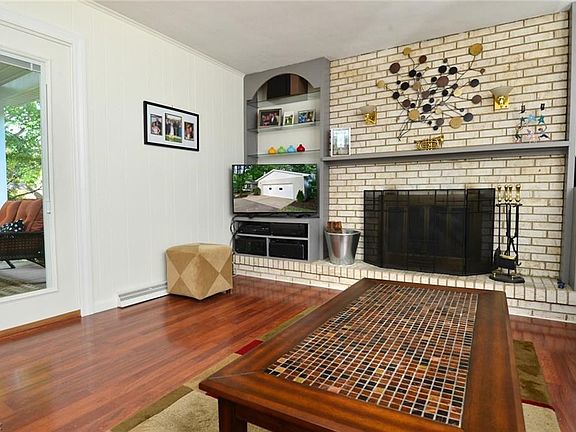 Relaxing Open Concept Kitchen and Family Room! Note doors leading covered deck viewing beautiful scaped yard.