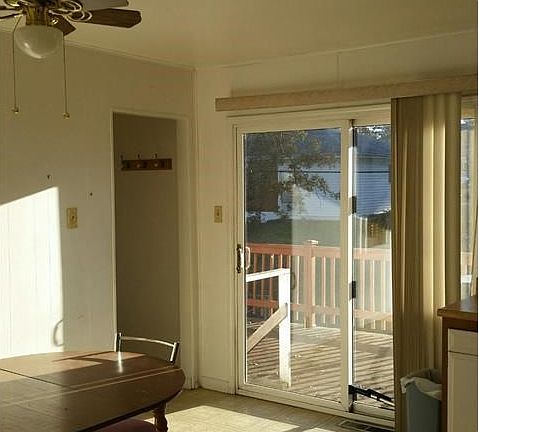 Sliding door leads from kitchen to spacious deck overlooking backyard.