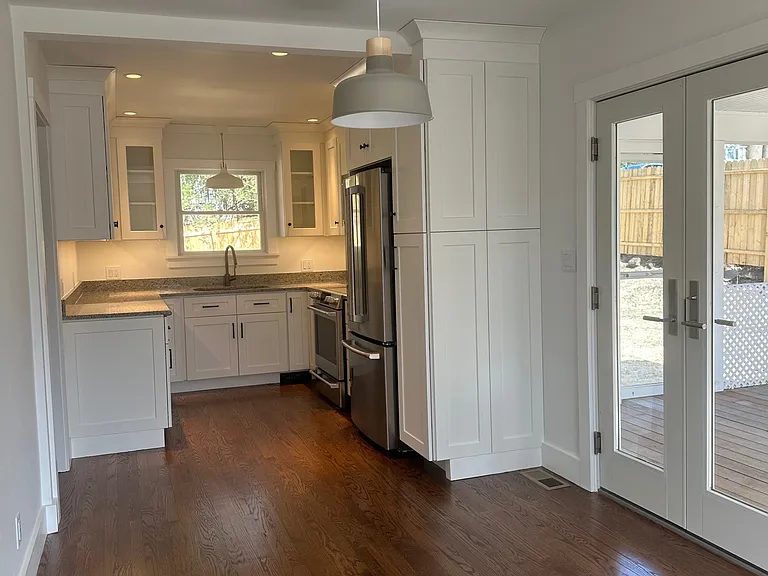 Kitchen, with French doors to screened in sun porch.