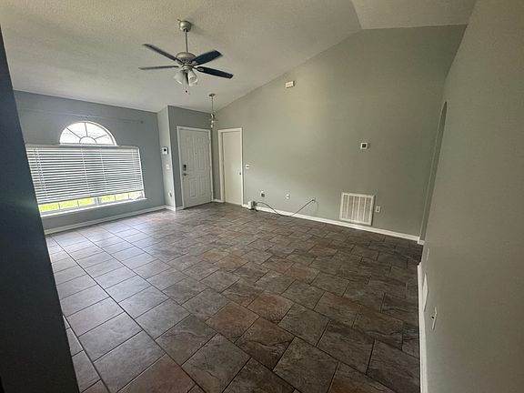 Living room with view of main and garage entry