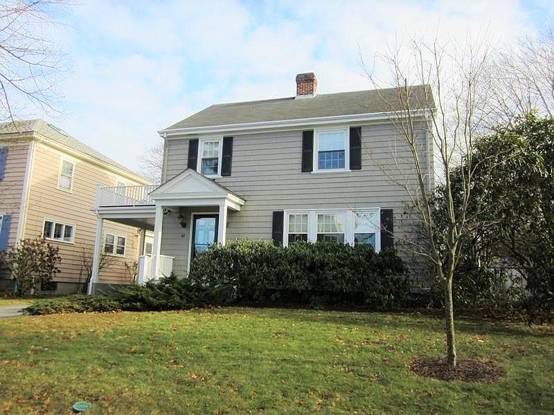 Front of House with adjacent covered parking area in driveway.