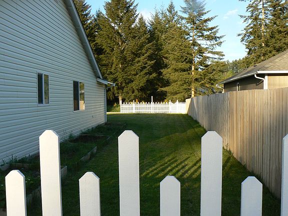 side view of yard beyond fence