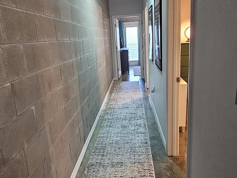 Hallway to two bedrooms and full bathroom