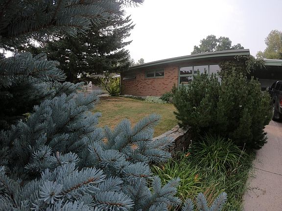 Mature trees and shrubs adorn the front and back yards.