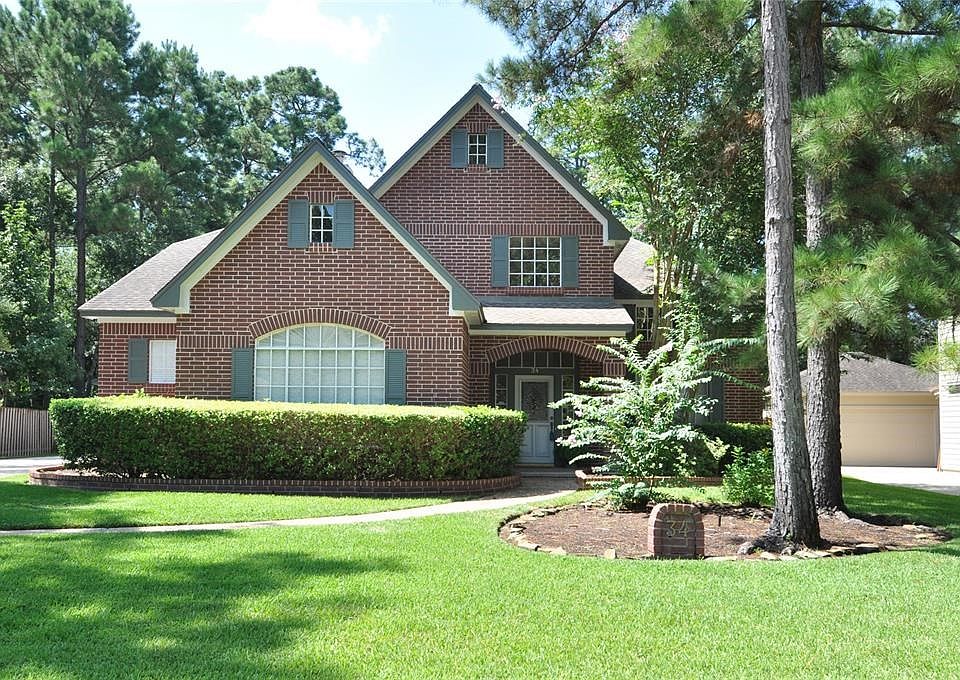 Classic red brick exterior invites you to explore this beautiful home nestled on Treescape Circle in The Woodlands.
