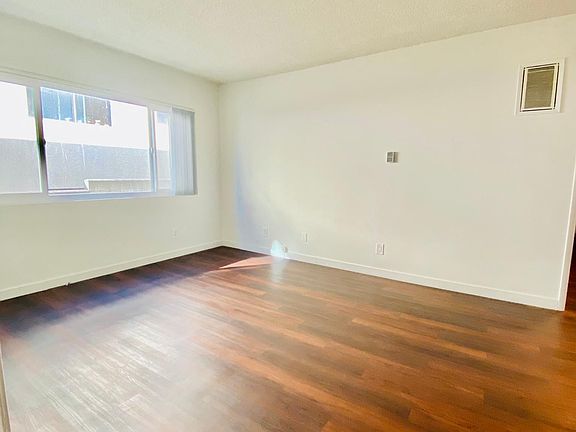 Spacious living room with large window.