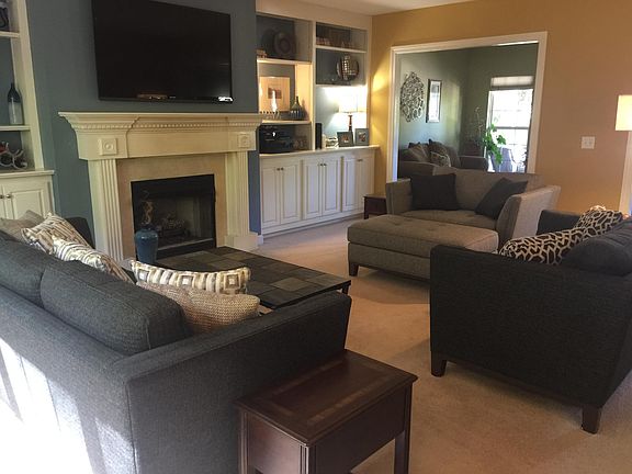 Large living room - working gas fireplace - wall-to-wall bookcases and cabinets